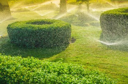 Automatic garden irrigation system watering green garden. Automatic garden irrigation system watering green garden. Spraying water from a lawn sprayers on a sunny summer day.